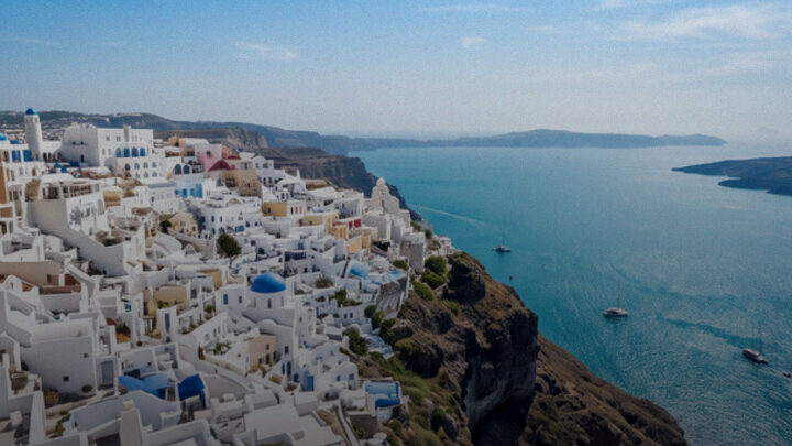 White Greek island houses above a blue sea